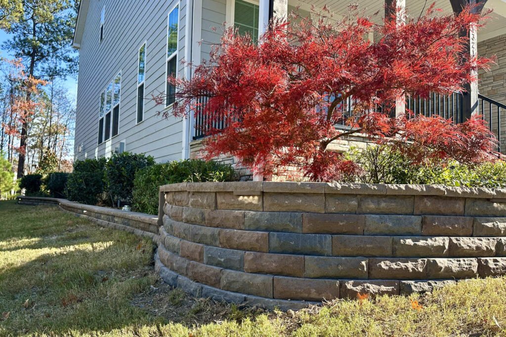 Stone flower bed edging installation for residential yard in North Carolina