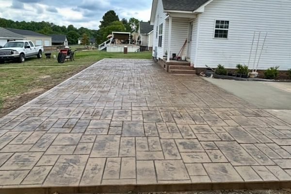 Stamped concrete with realistic stone texture installed by Limitless Boundaries LLC in Garner, NC