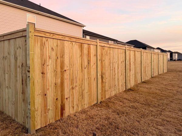 wood-cap-and-trim-fence-installed-in-angier